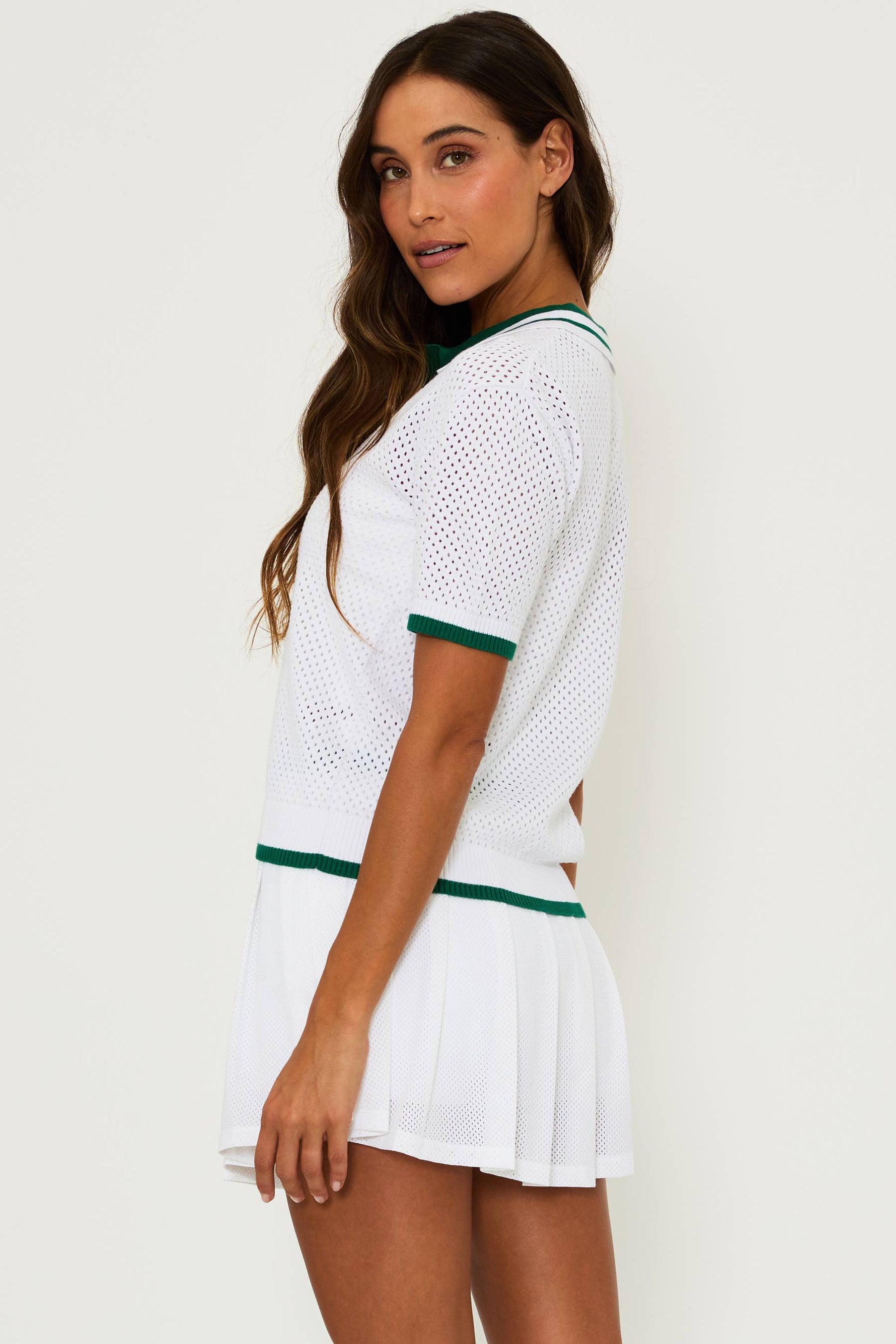 white mesh top with green contrast trim on the collar, cuffs and hem