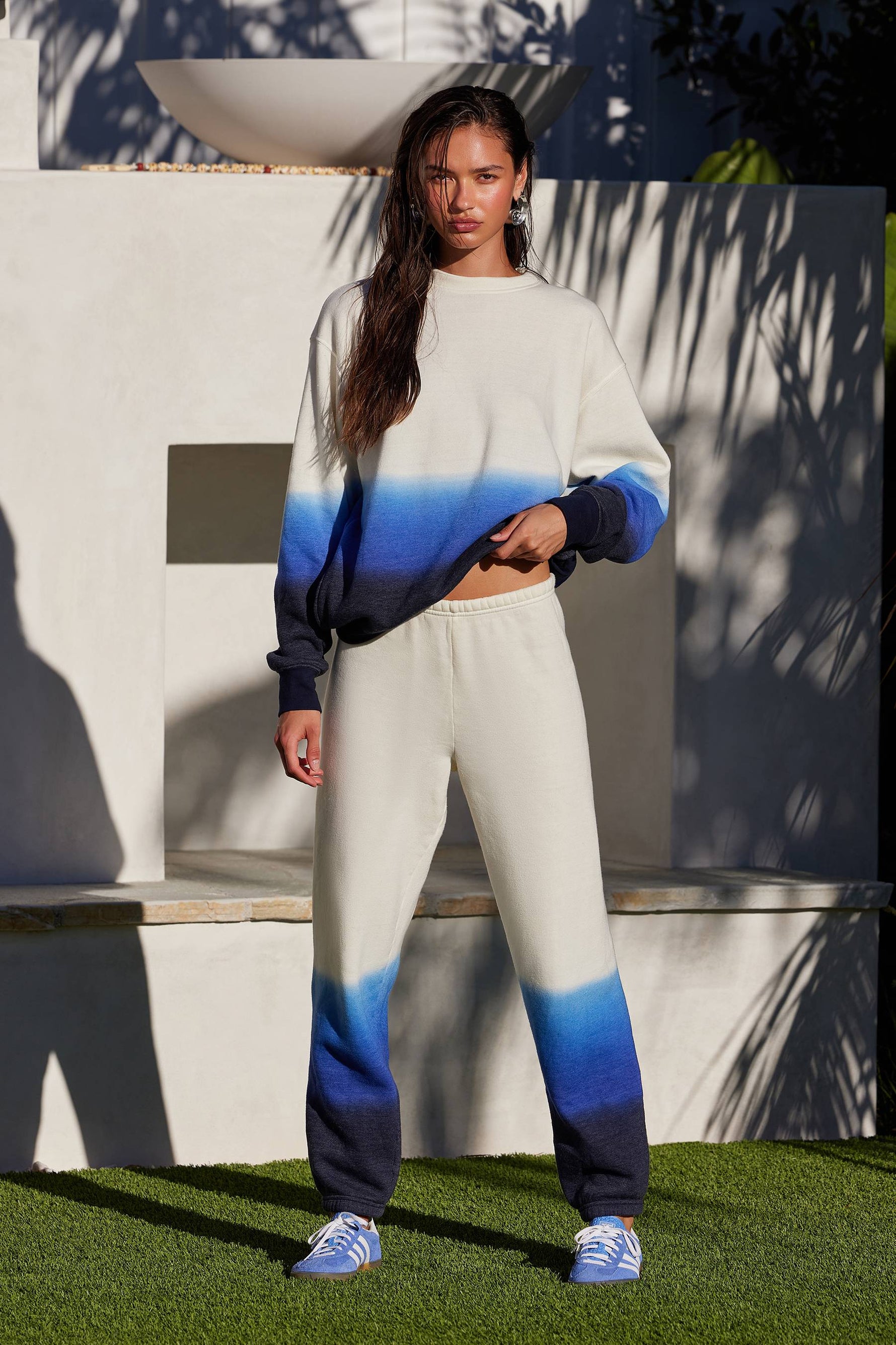 Model wearing Nash Sweatpant in egret ombre color, featuring a relaxed fit with smocked elastic waistband and cinched bottom hems.