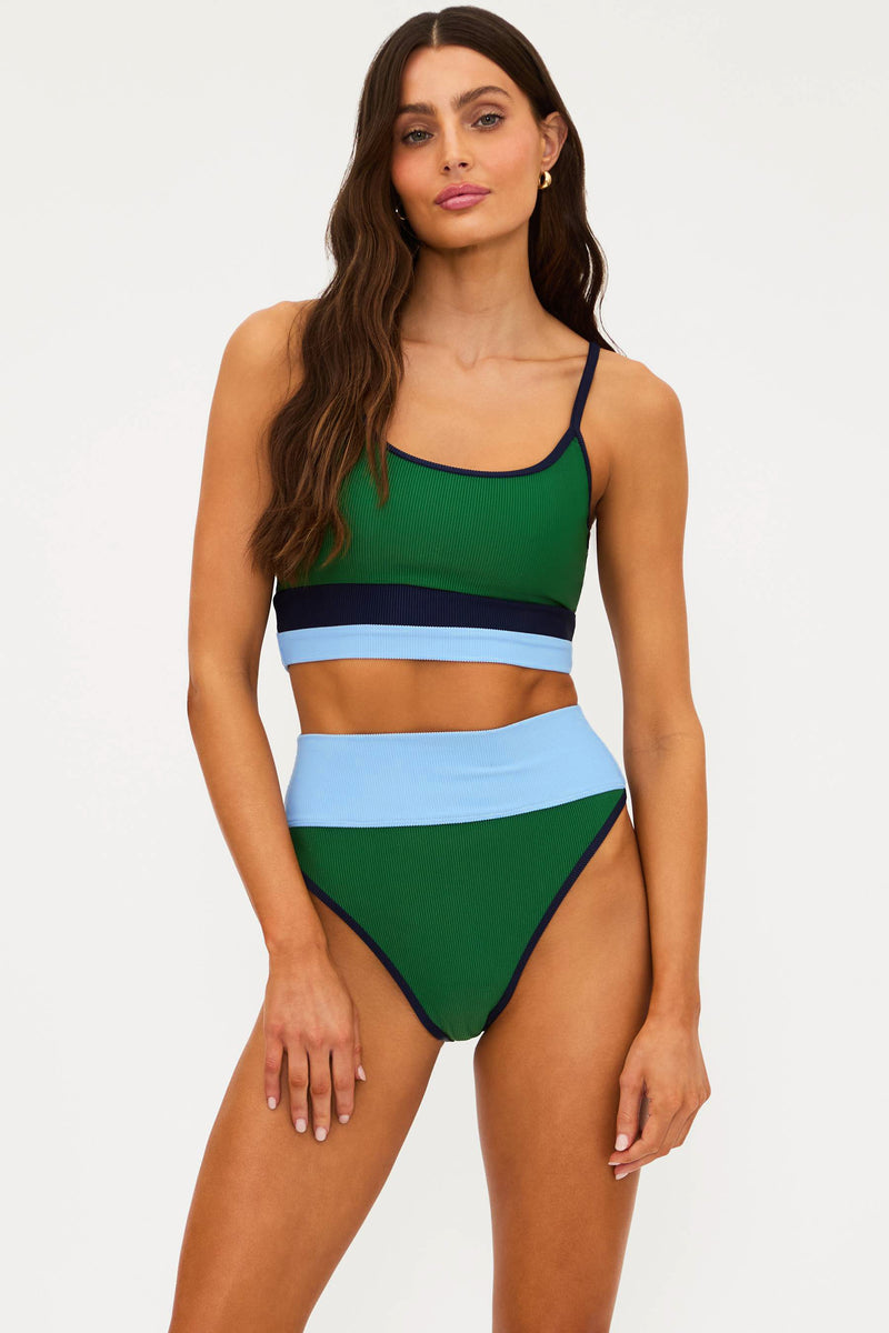 Woman wearing a colorful two-piece swimsuit on a white background