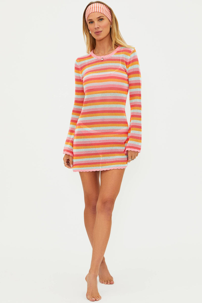 Woman wearing a colorful striped dress on a white background