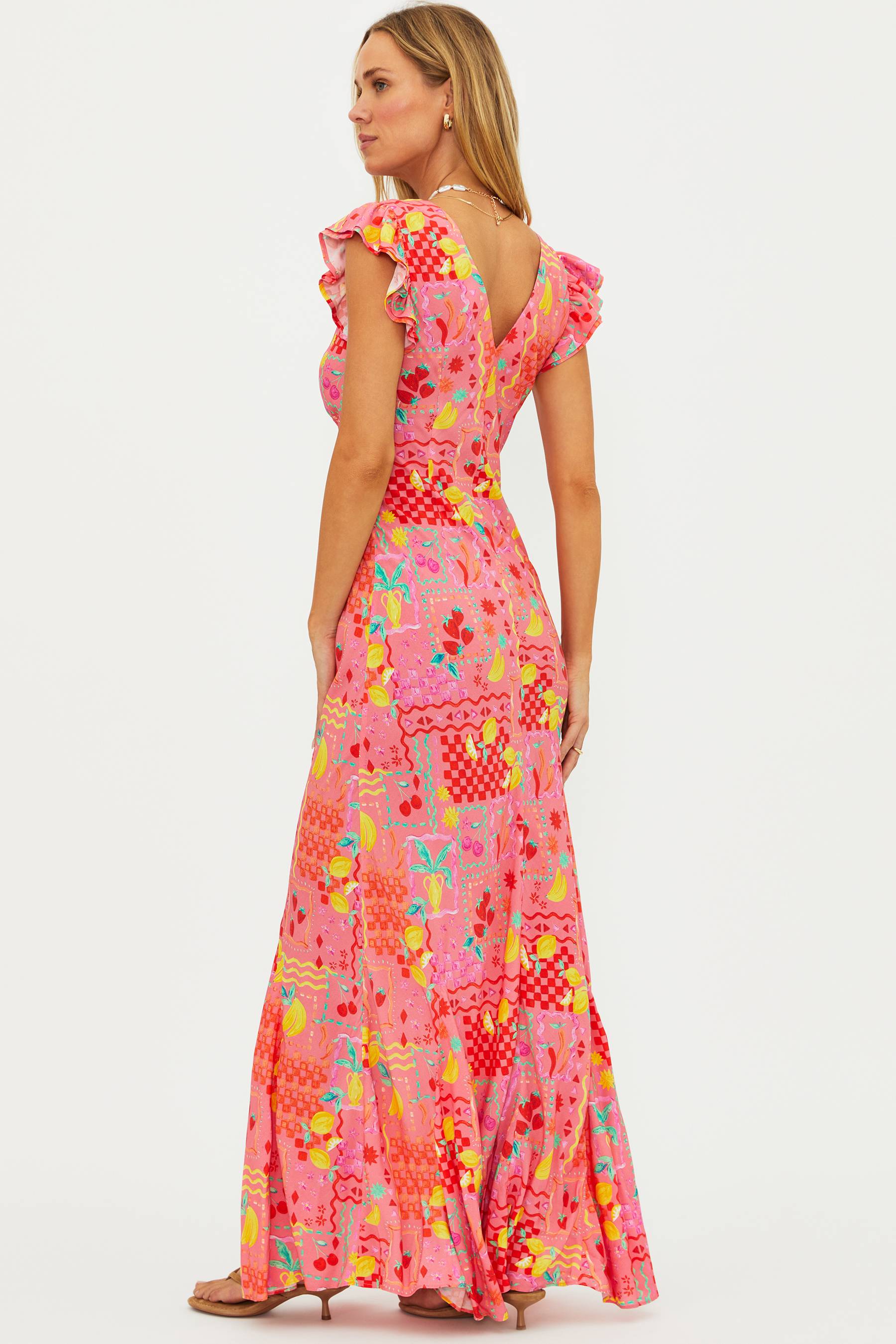 Woman wearing a colorful patterned dress on a white background