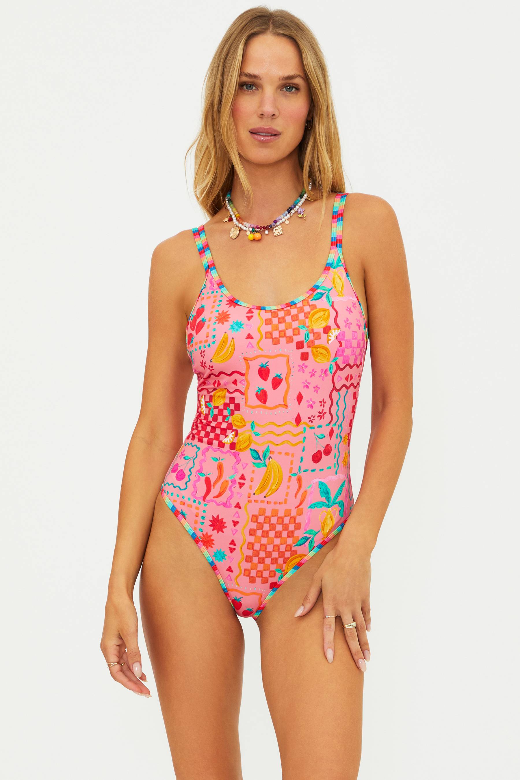 Woman wearing a colorful patterned swimsuit on a white background