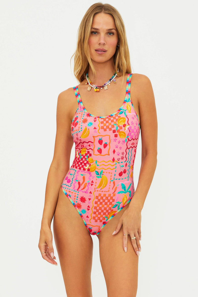 Woman wearing a colorful patterned swimsuit on a white background