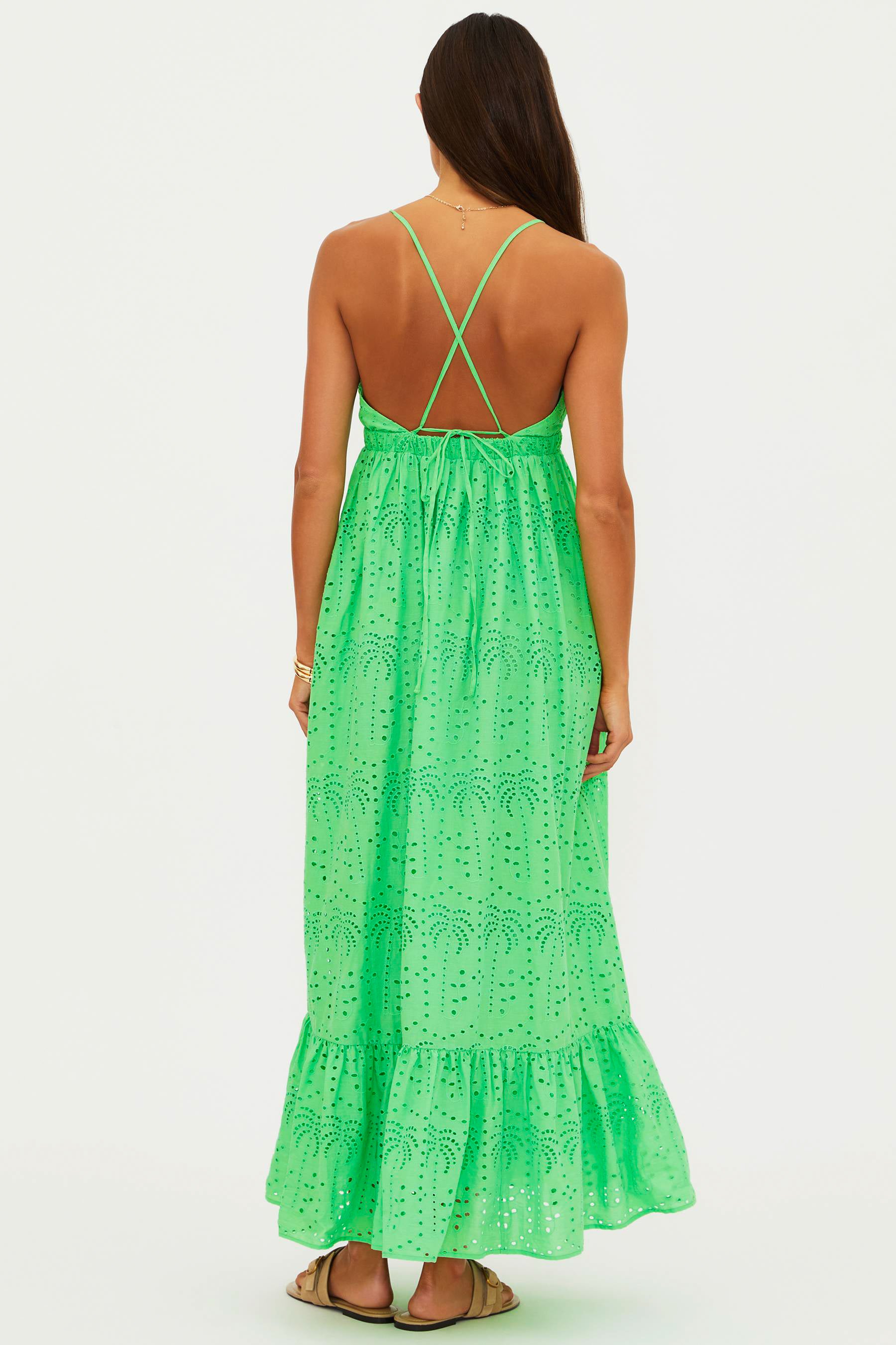 Green lace dress worn by a person on a white background