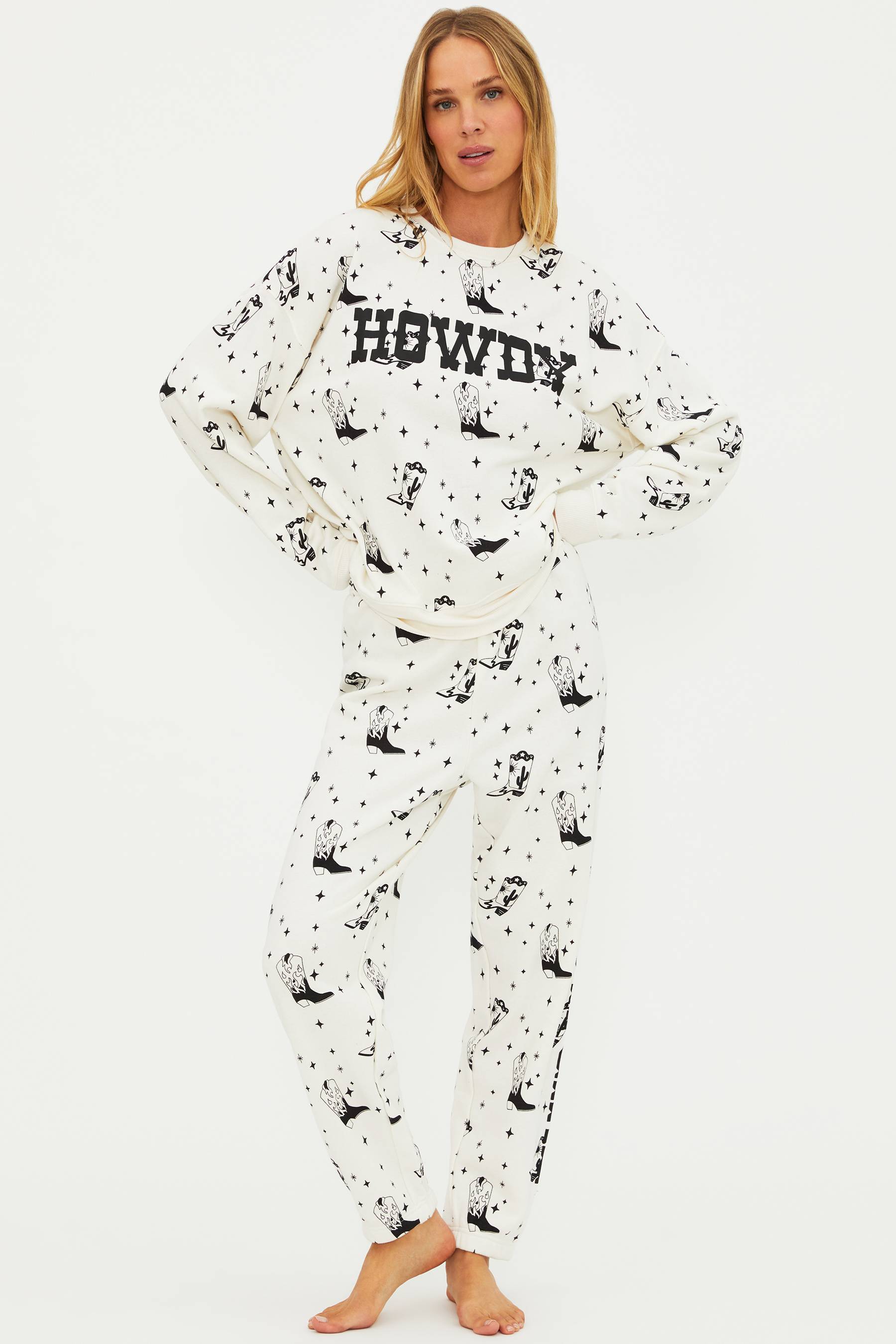 Woman wearing a white pajama set with black patterns and text on a white background