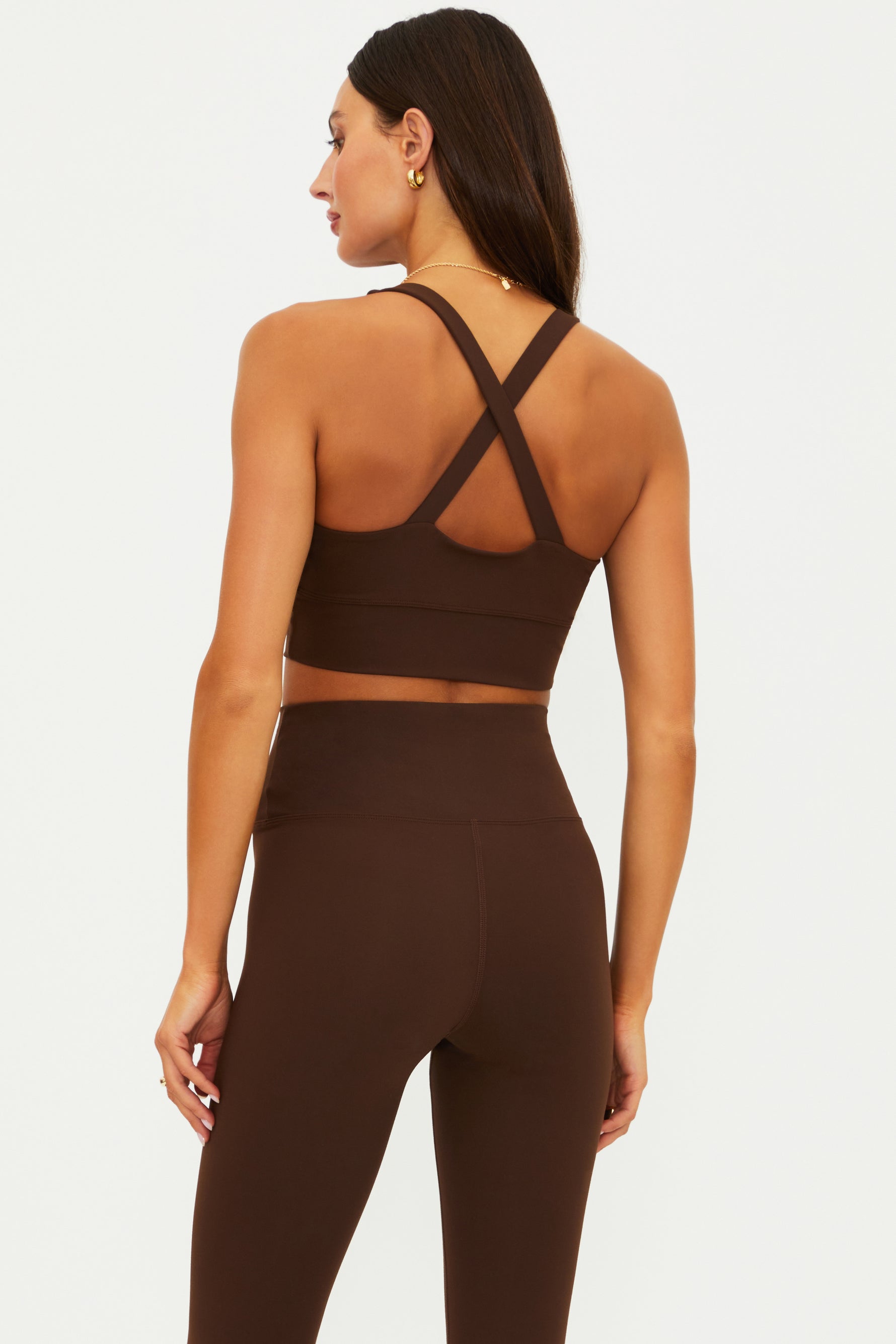 Brown sports bra and leggings set on a white background