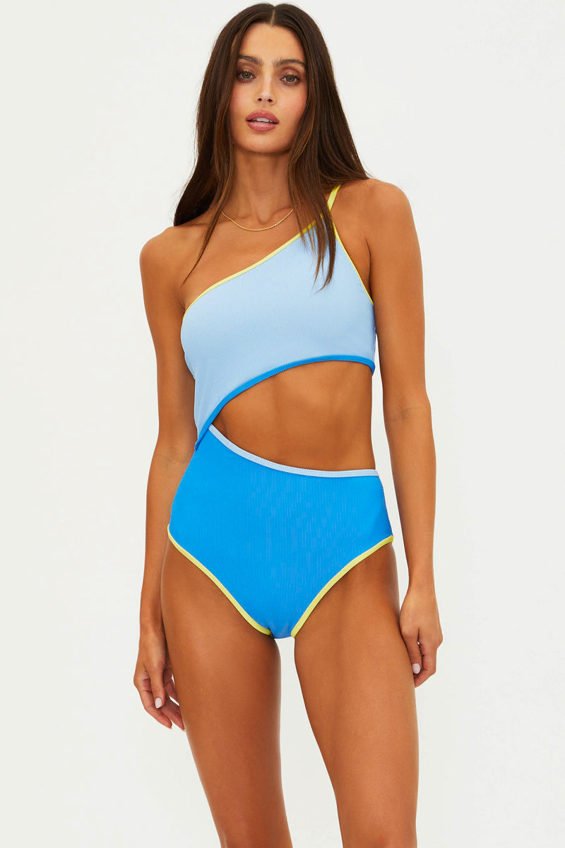 Woman wearing a blue and light blue one-piece swimsuit on a white background