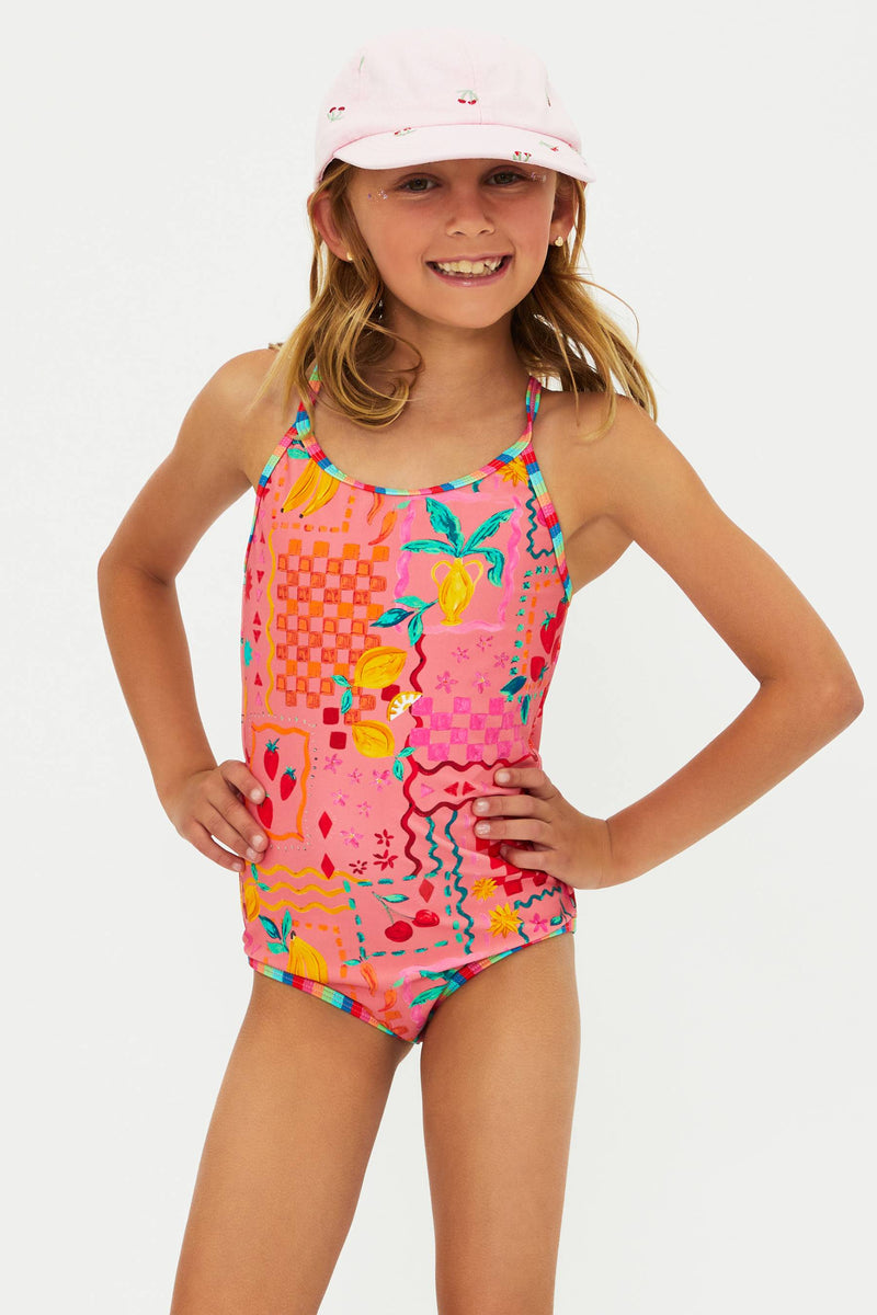 Young girl wearing a colorful swimsuit and pink cap on a white background