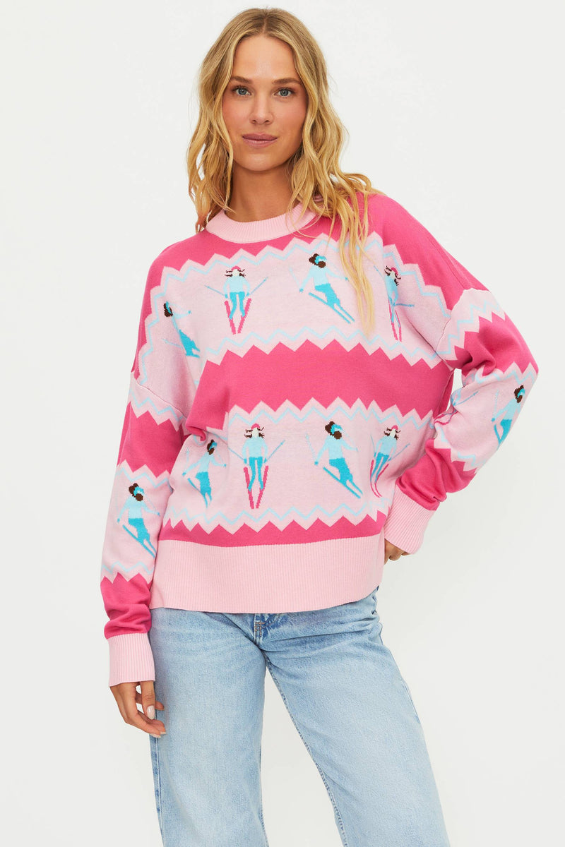 Woman wearing a pink sweater with ice cream cone pattern on a white background