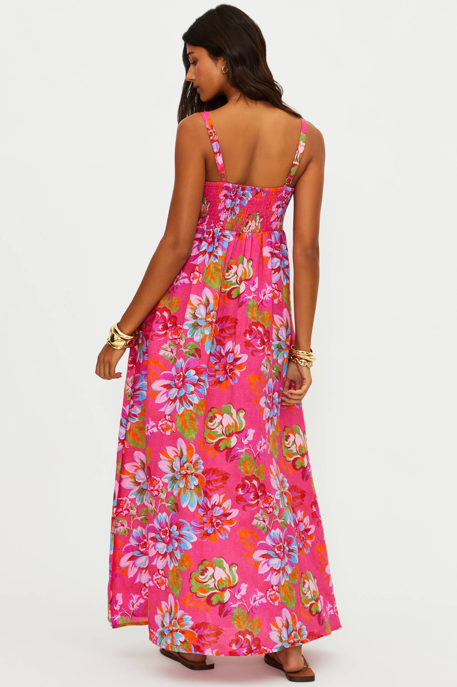 Woman wearing a pink floral dress on a white background