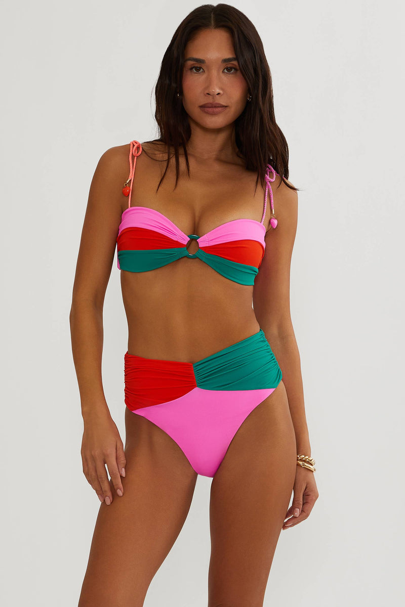 Woman wearing a colorful bikini set on a white background