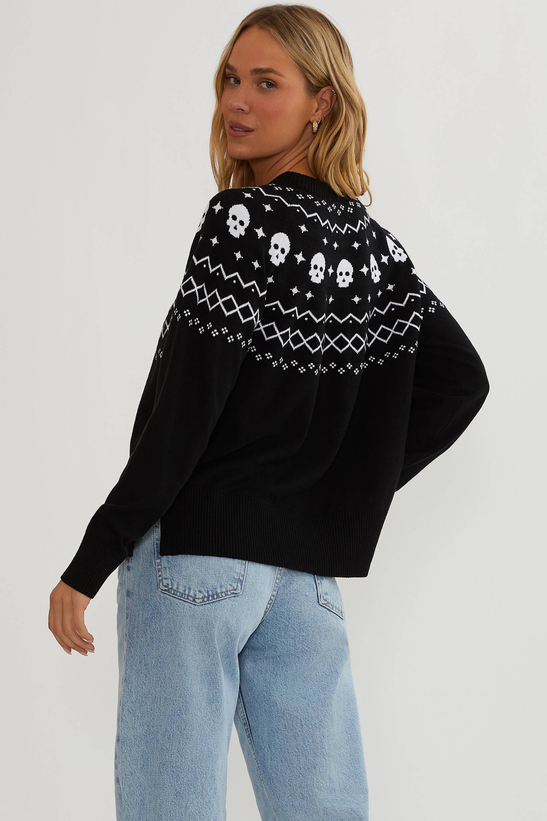 Black sweater with white detailing and white skulls.