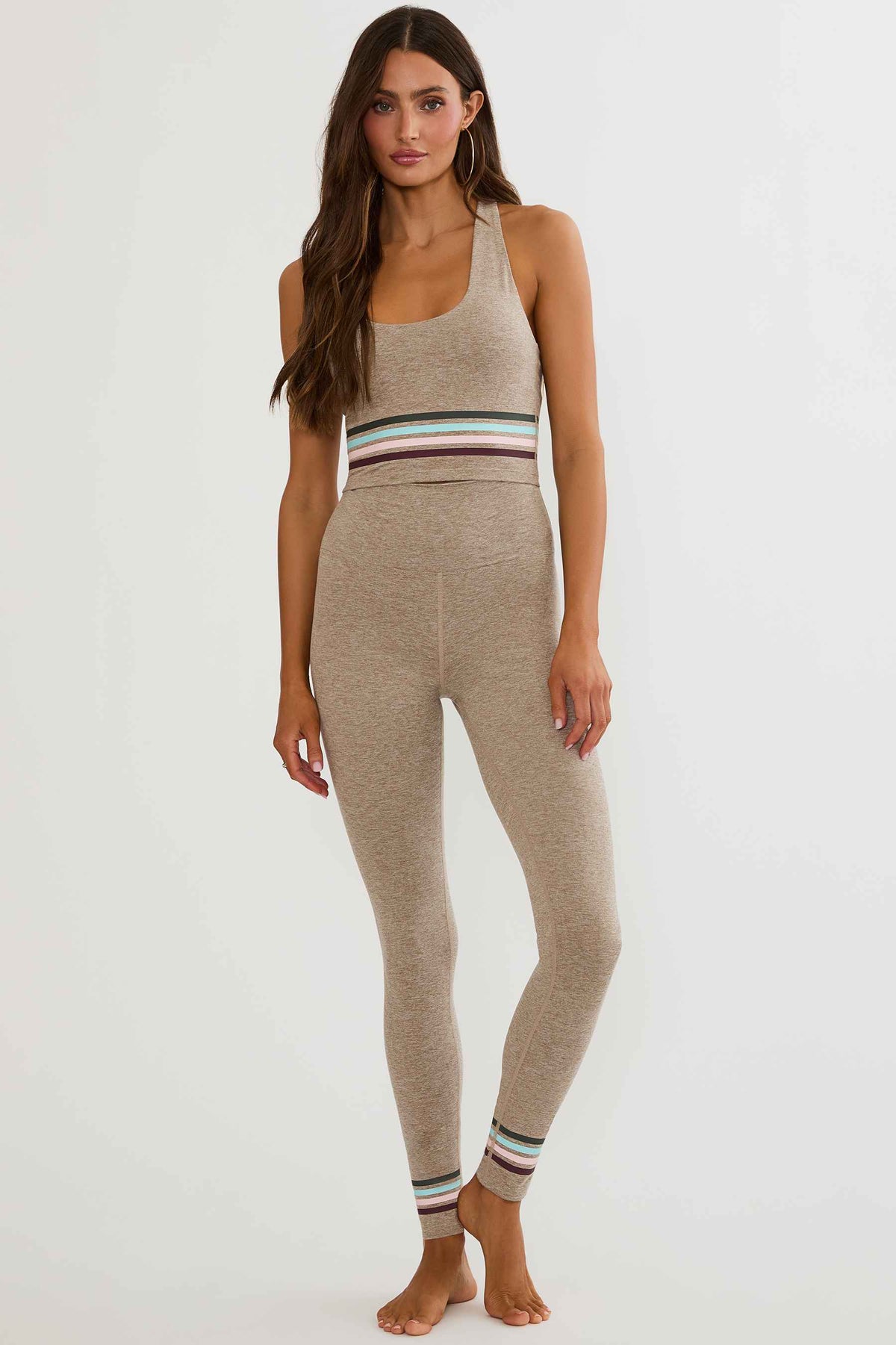 Beige high waisted legging with colorful lining around the ankles. 