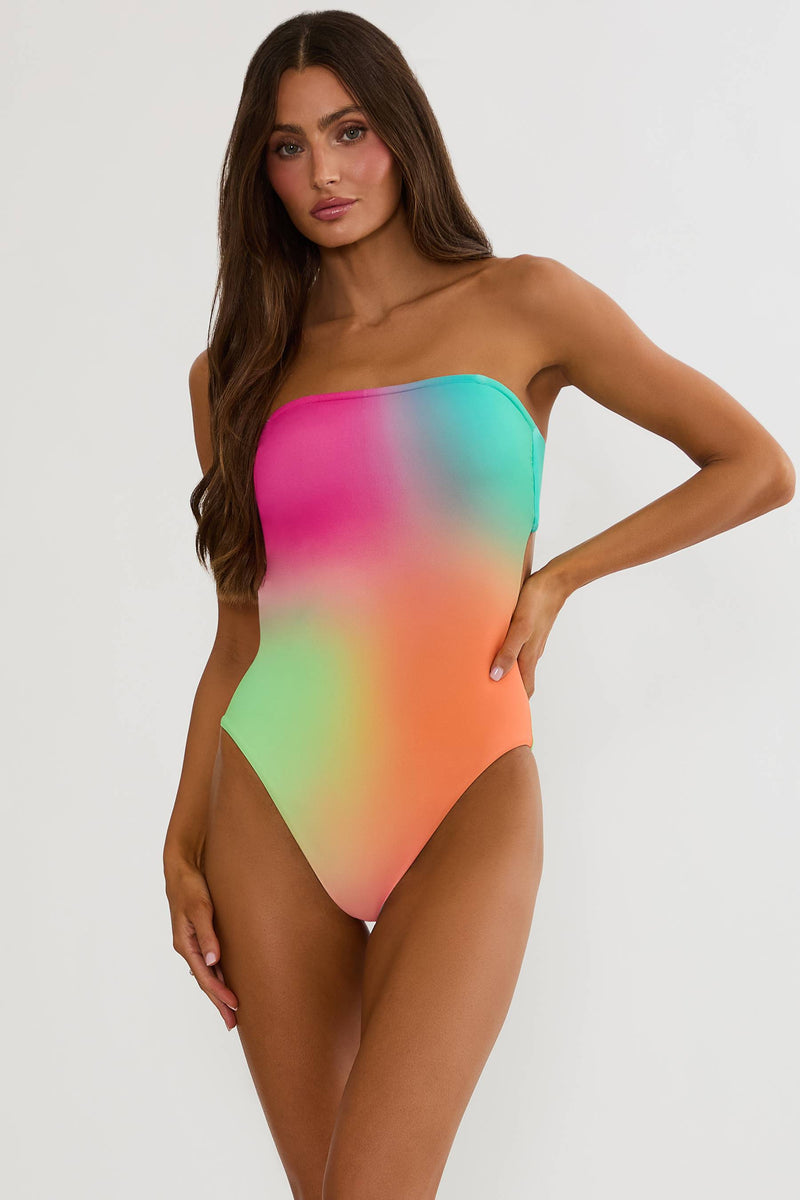Woman wearing a colorful strapless swimsuit on a white background