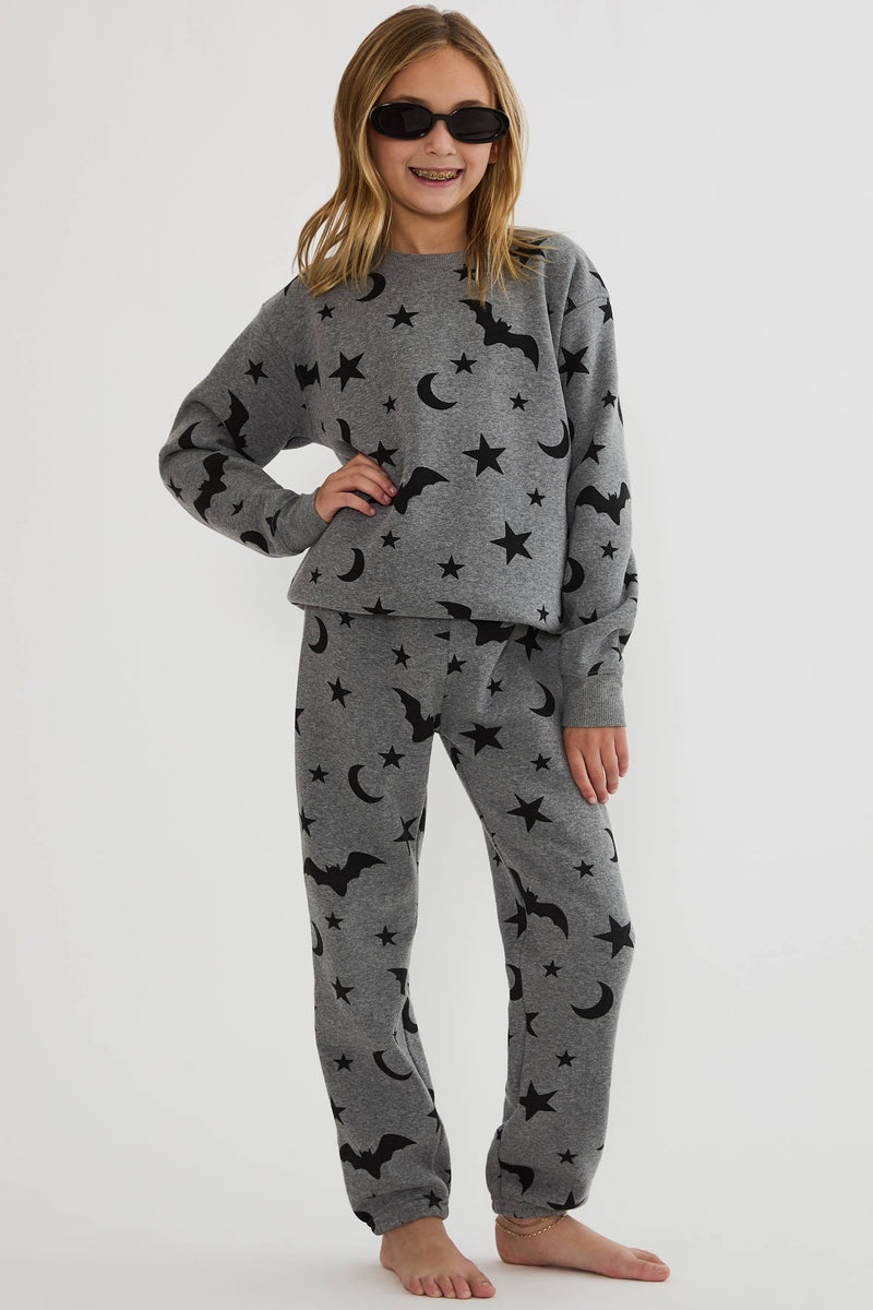 Kids grey sweatpants with black stars, moon, and bats. 