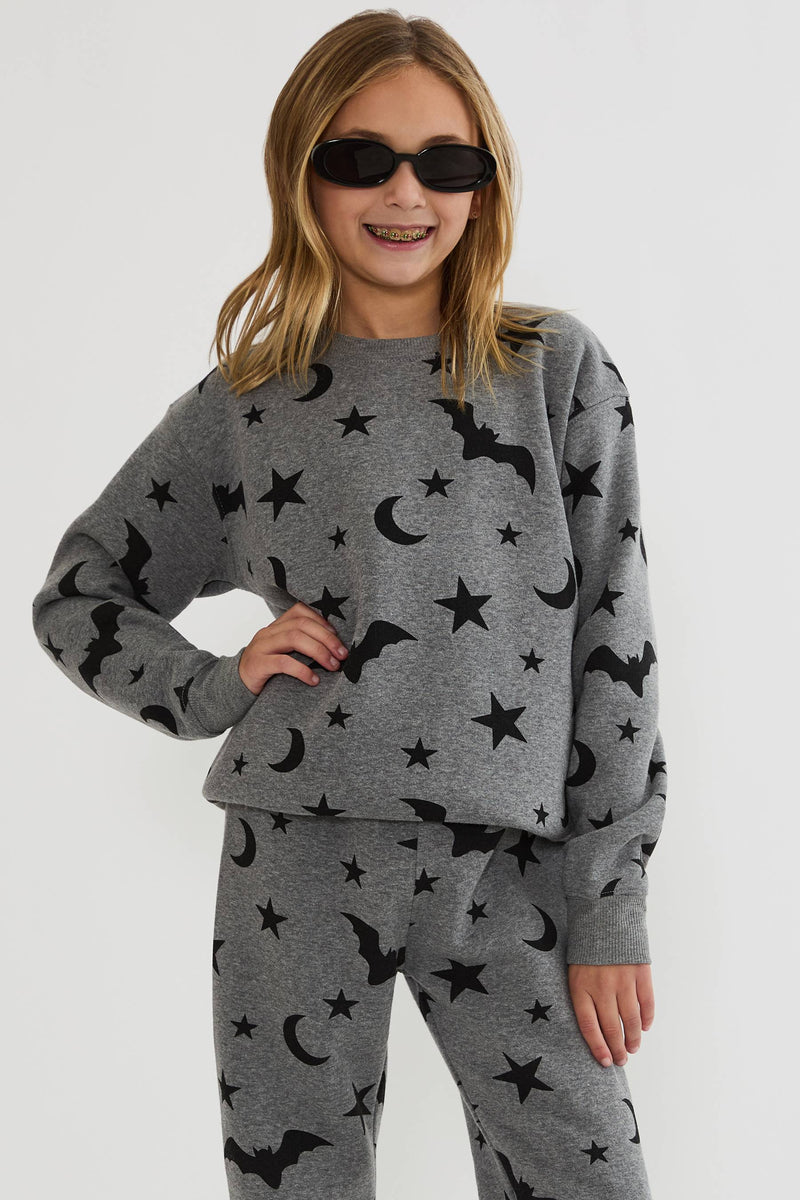 Kids grey sweatshirt with black stars, moons, and bats. 