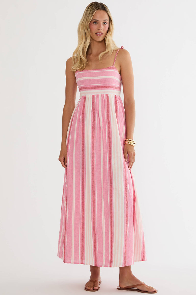 Woman wearing a pink and white striped dress on a white background