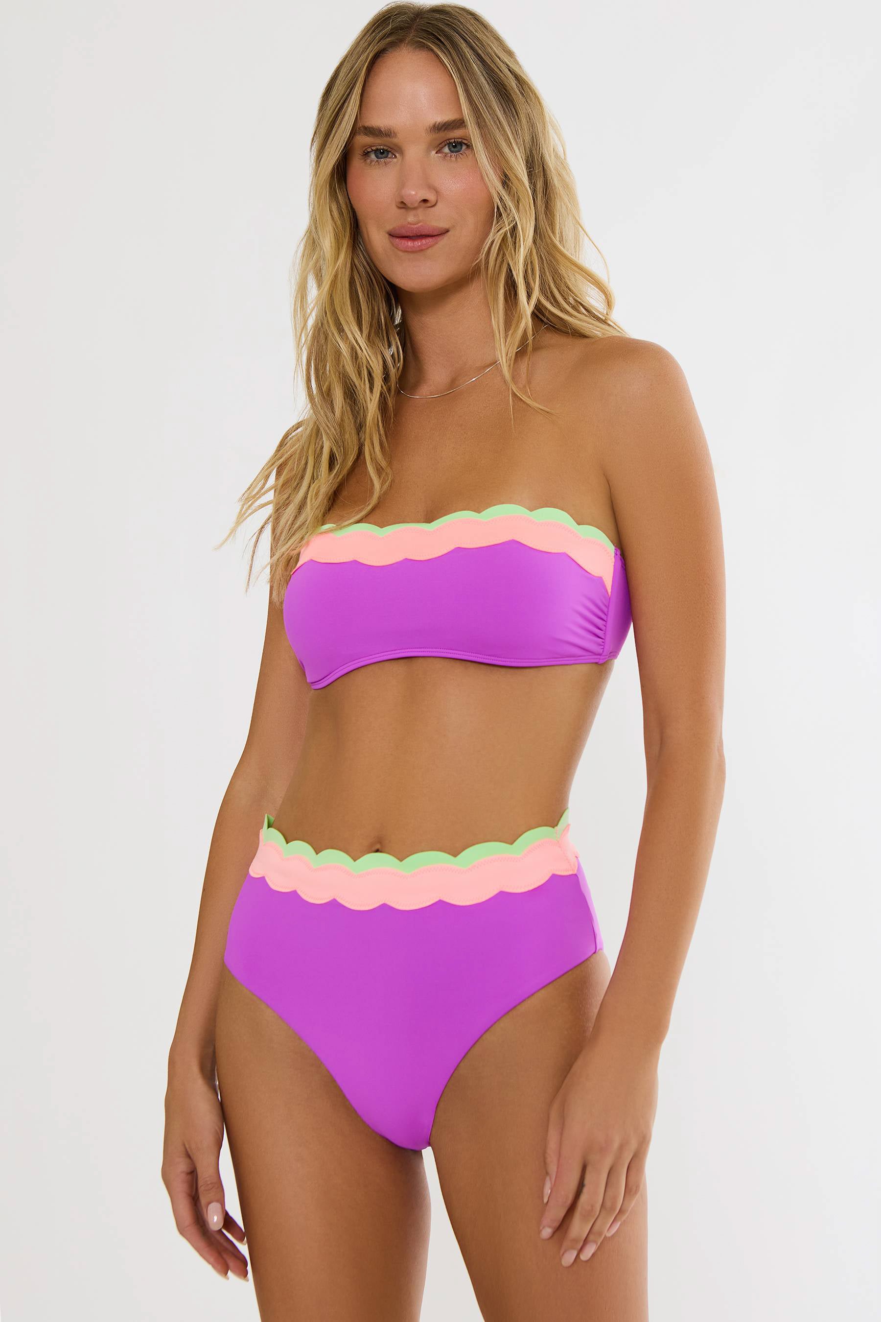 Woman wearing a colorful bikini with a white background