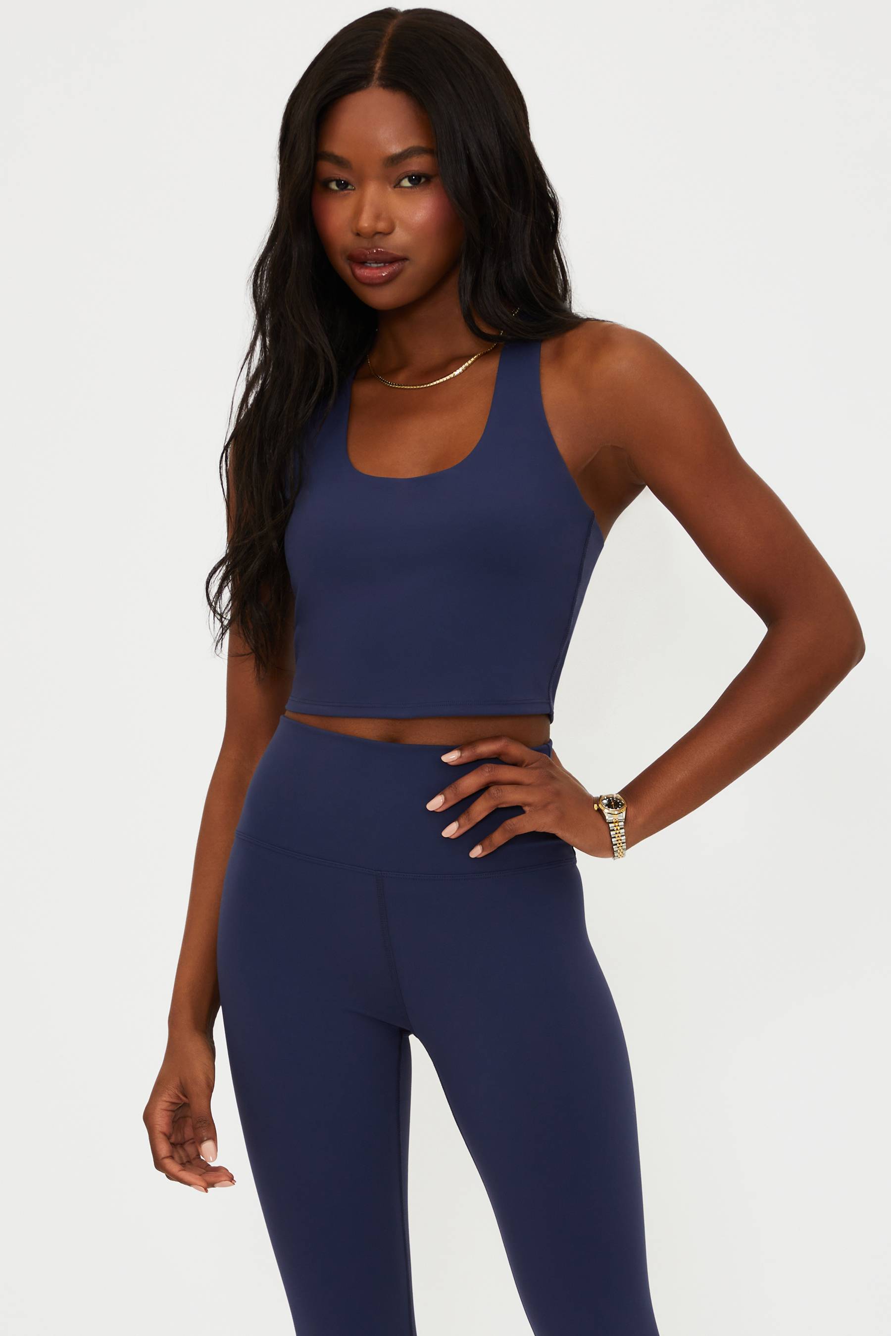 Woman wearing a blue athletic outfit on a white background