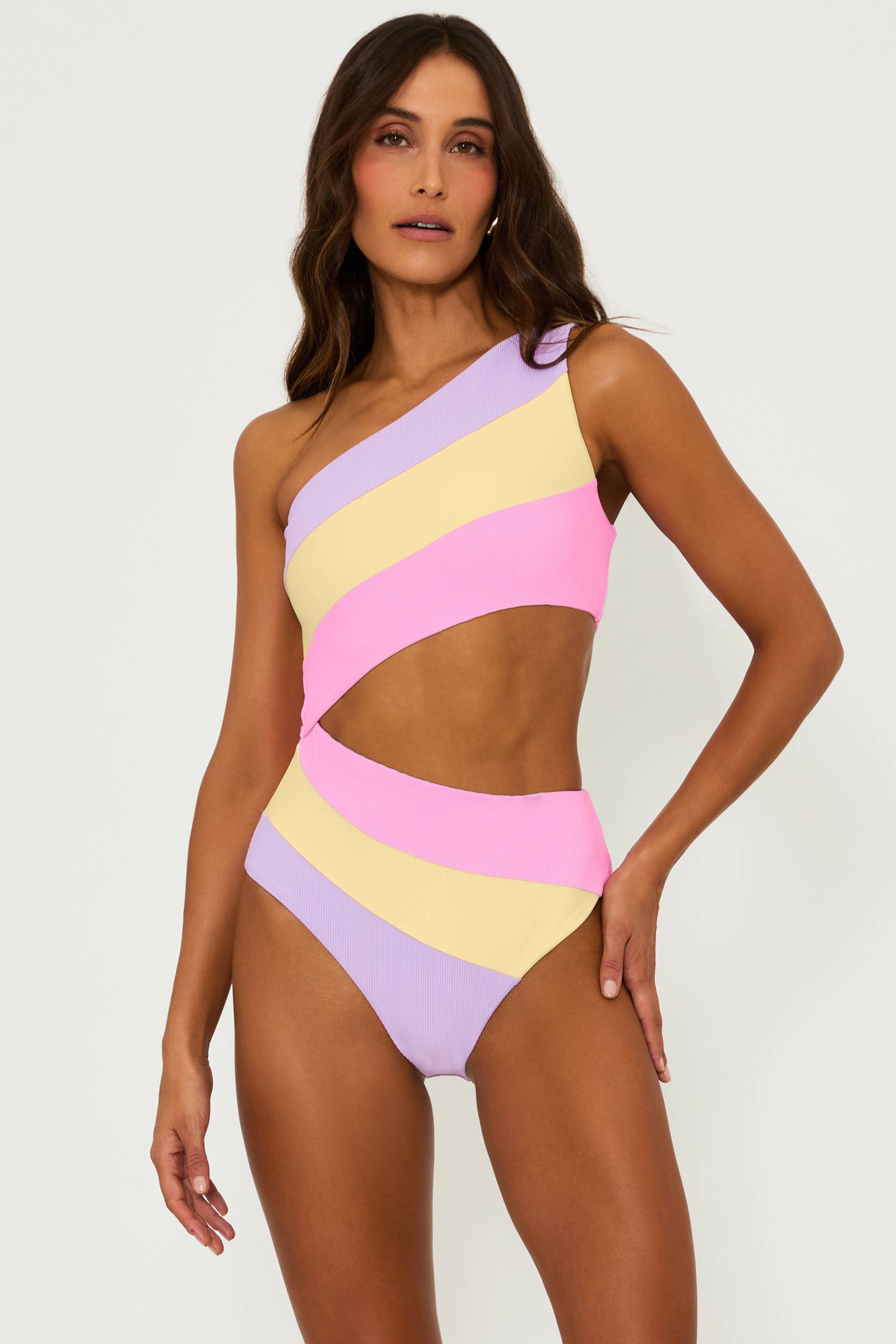 Pink, yellow and purple ribbed one piece swimsuit with one strap and a cut out detail