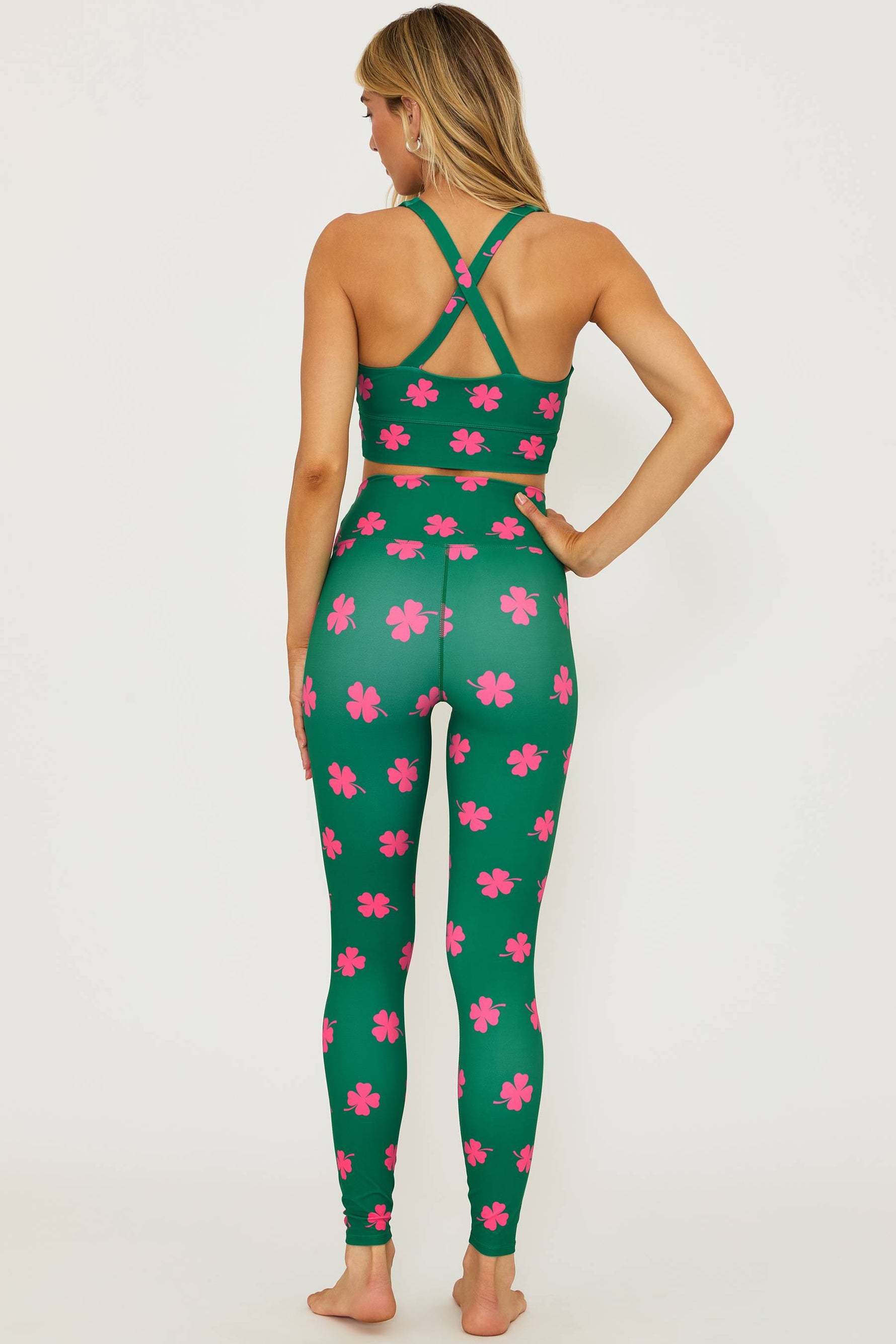 green leggings with a pink clover print all over