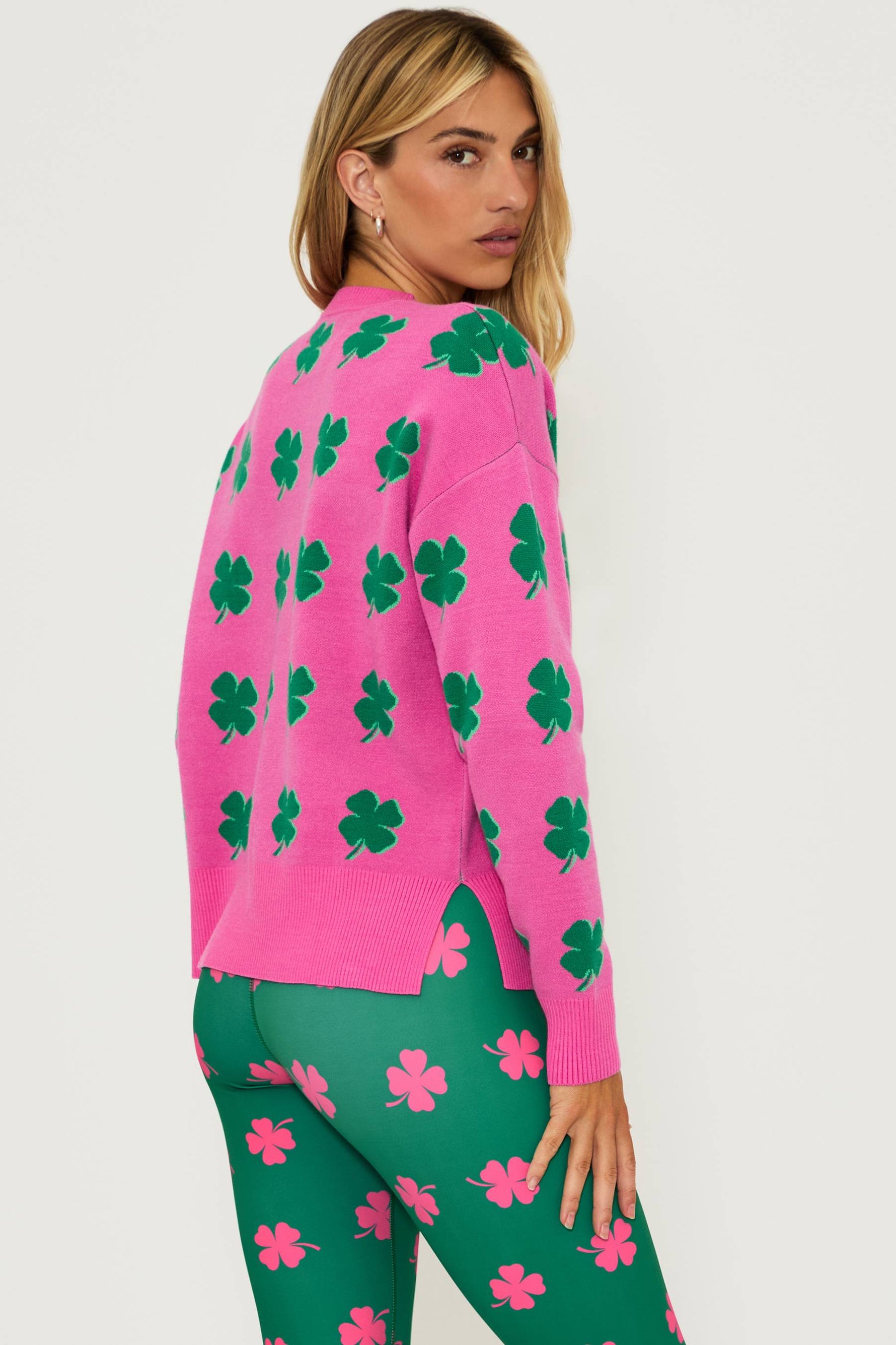 Pink sweater with green clover print