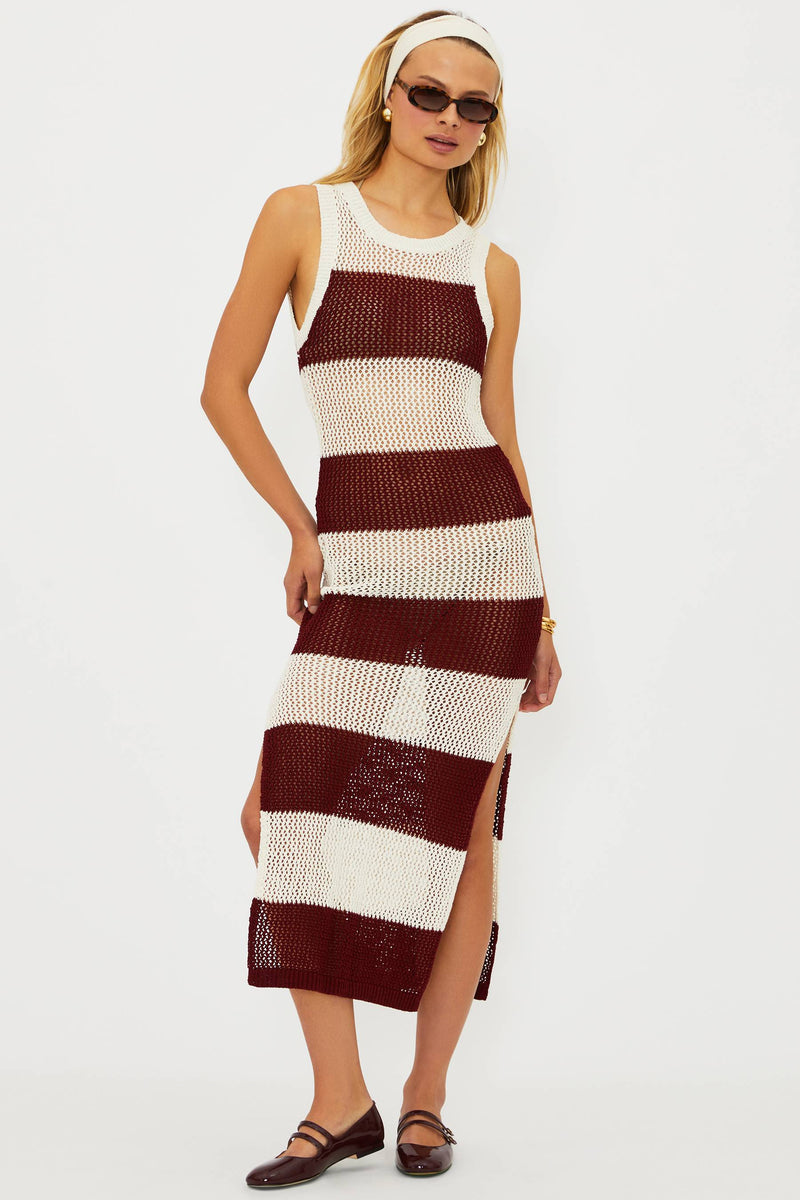 Woman wearing a maroon and white striped dress on a white background