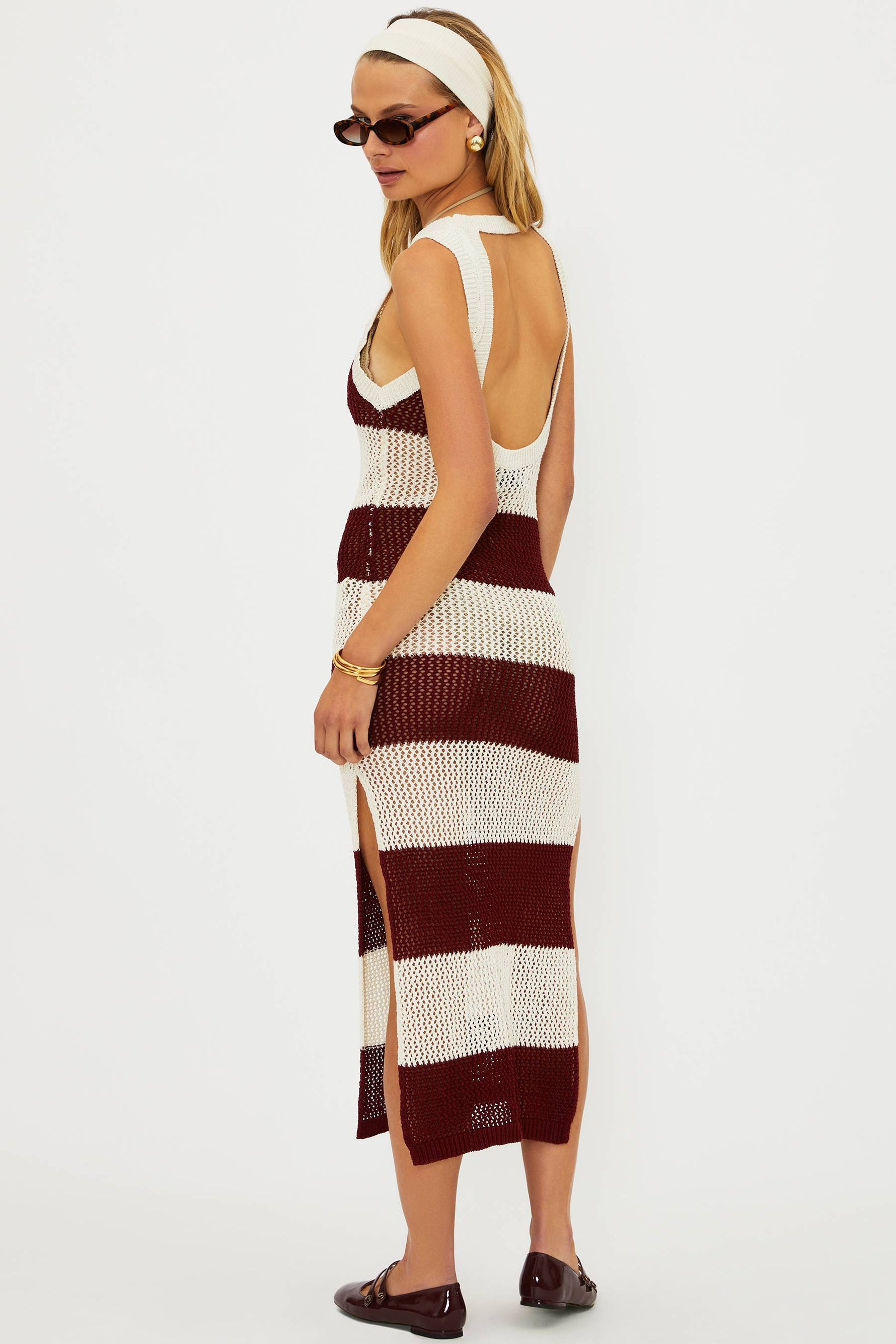 Woman wearing a striped dress with a white background