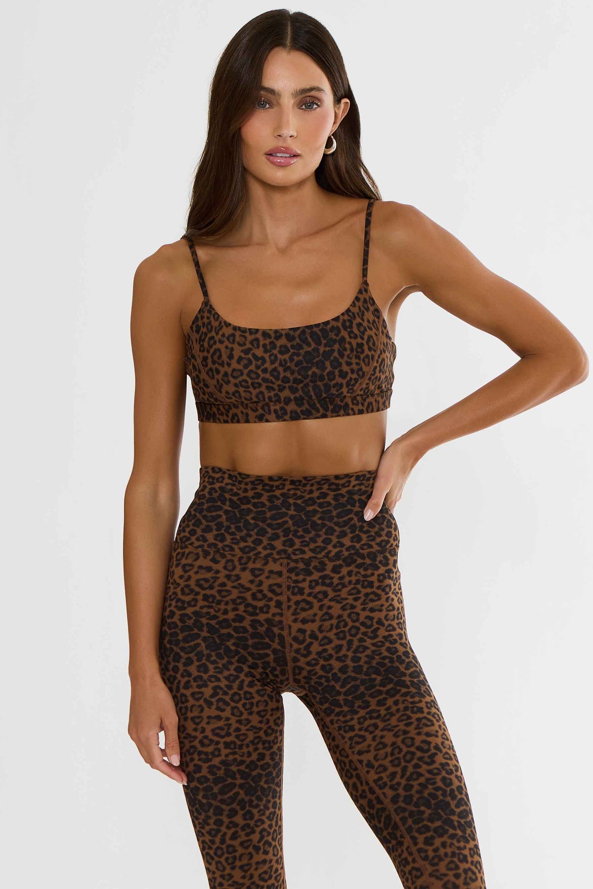Woman wearing a brown and black leopard sports bra. 