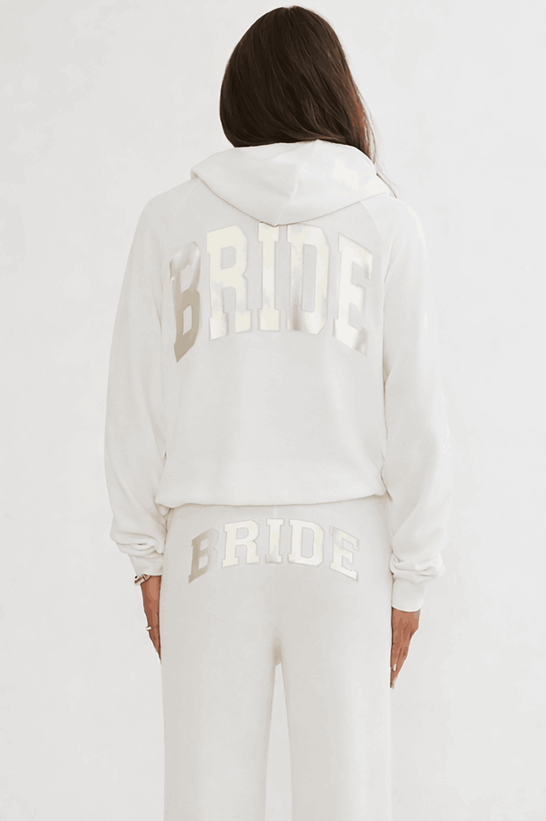 White hoodie with 'BRIDE' printed on the back, worn by a person against a white background