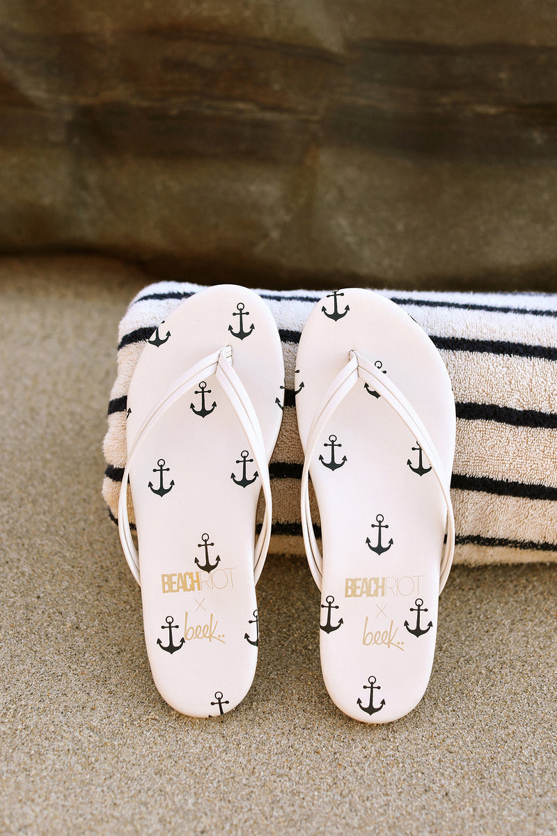 White flip flops with navy anchors.