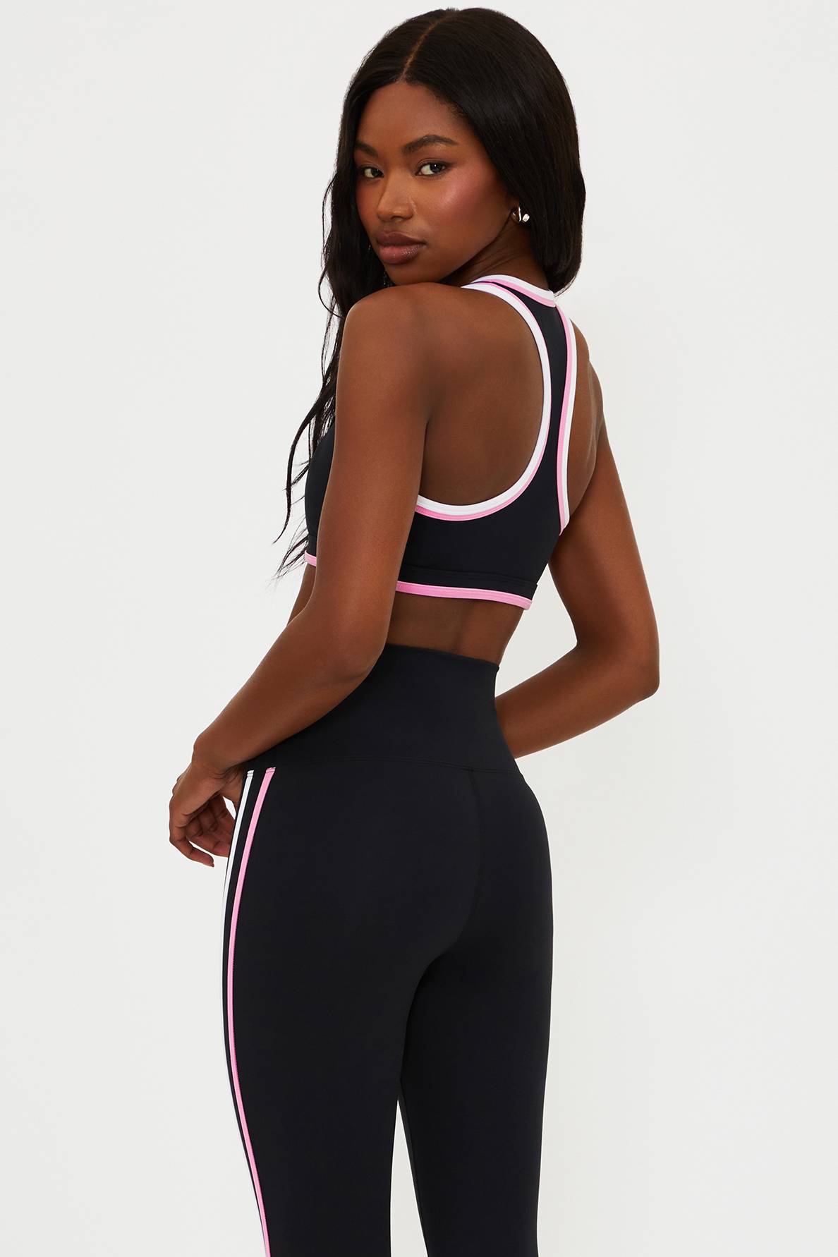 black scoop neck racer back sports bra with pink and white piping 