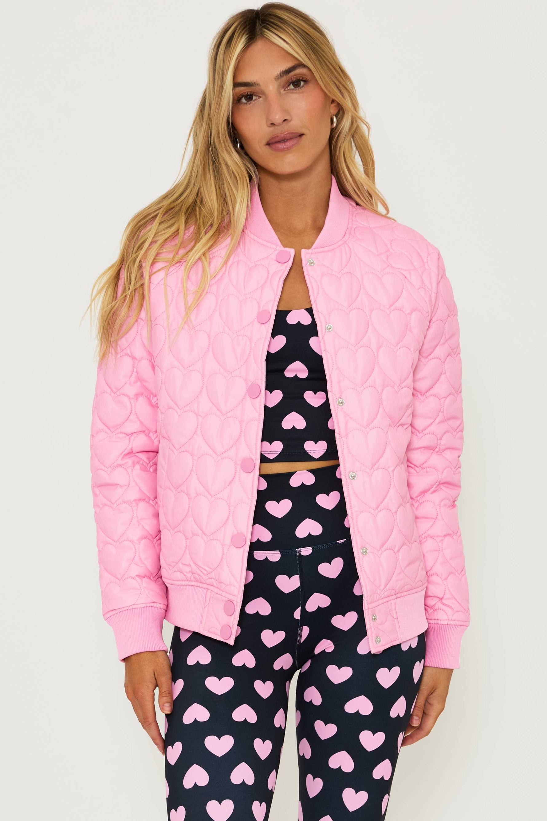 light pink puffer coat with quilted heart print all over