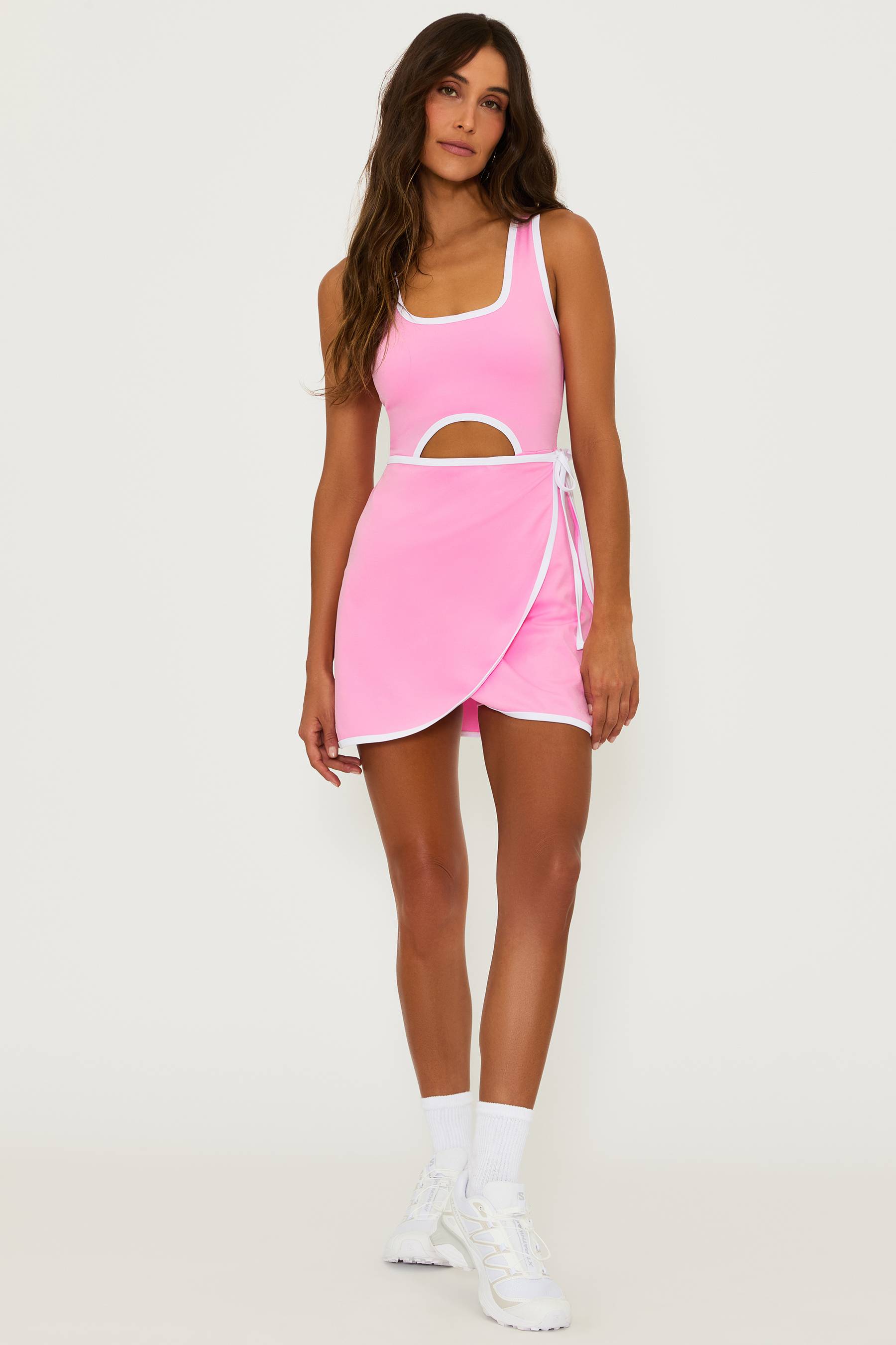 Pink tennis dress with a white contrast trim and cut out detail in the middle