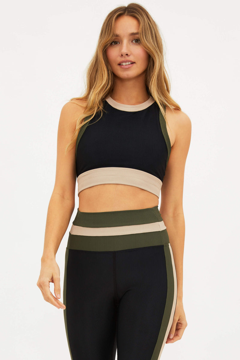 A woman wearing a military olive colorblock ribbed crop sports top with a high neckline and racerback detail.