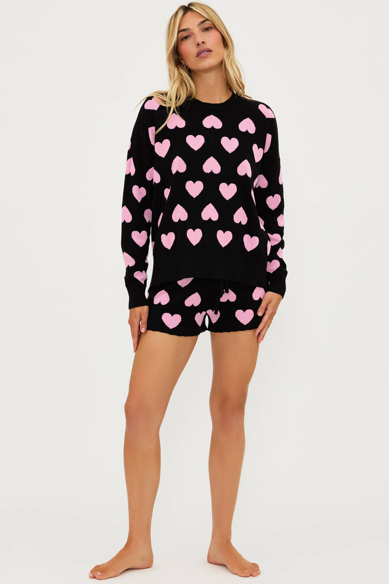black sweater with pink heart print all over and matching black shorts with light pink hearts