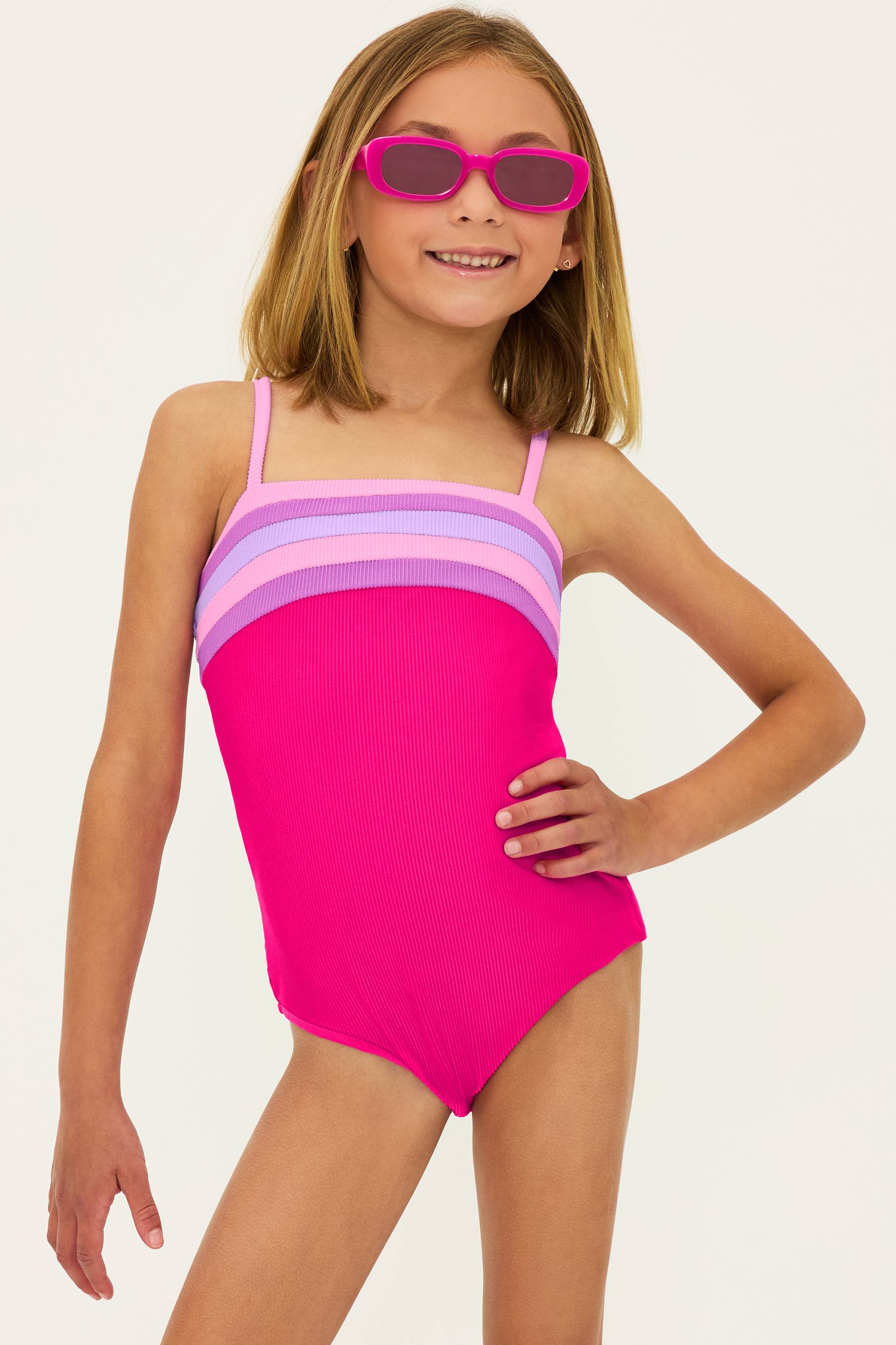 magenta ribbed one piece swim suit for little girls with pink and purple stripes on the top