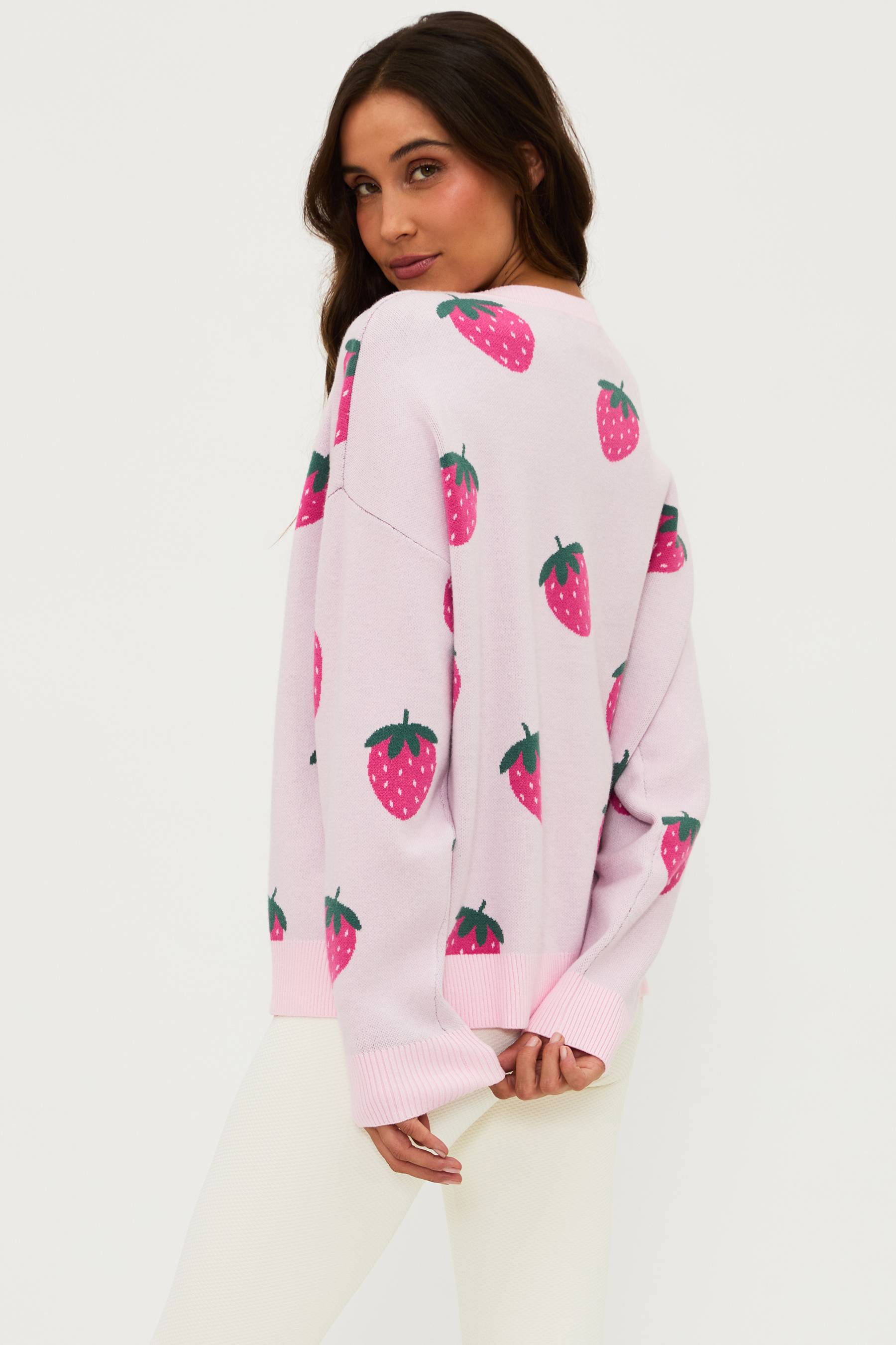 light pink v neck sweater with strawberries printed all over