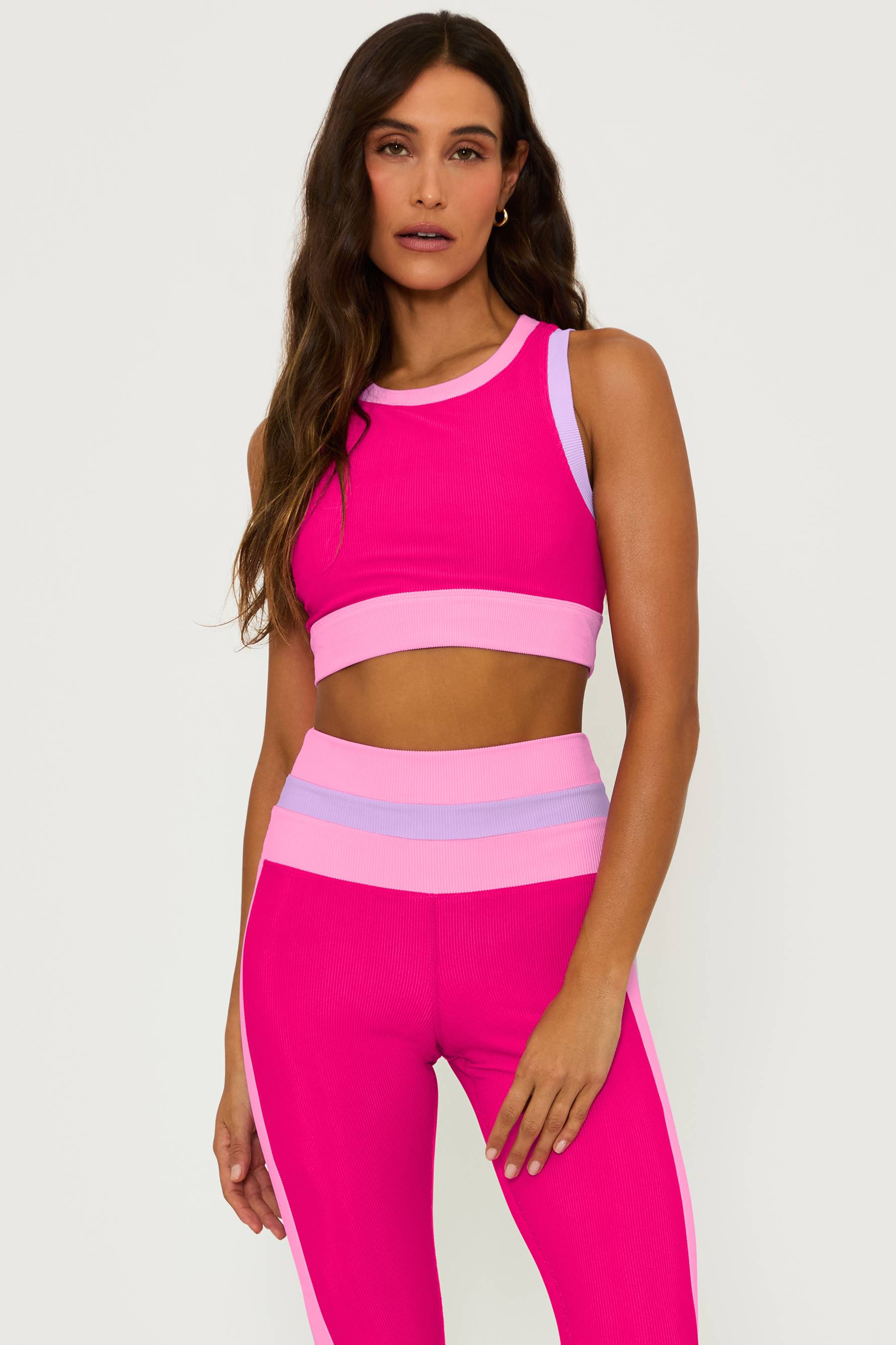 ribbed magenta high neck sports bra with pink and purple contrast trim