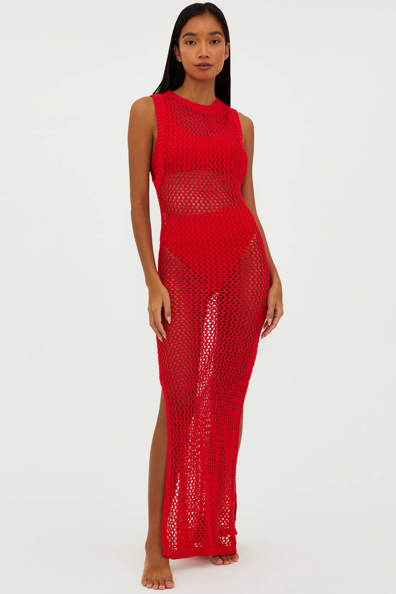 A model wearing a red crochet maxi dress with a high neck and side slits.