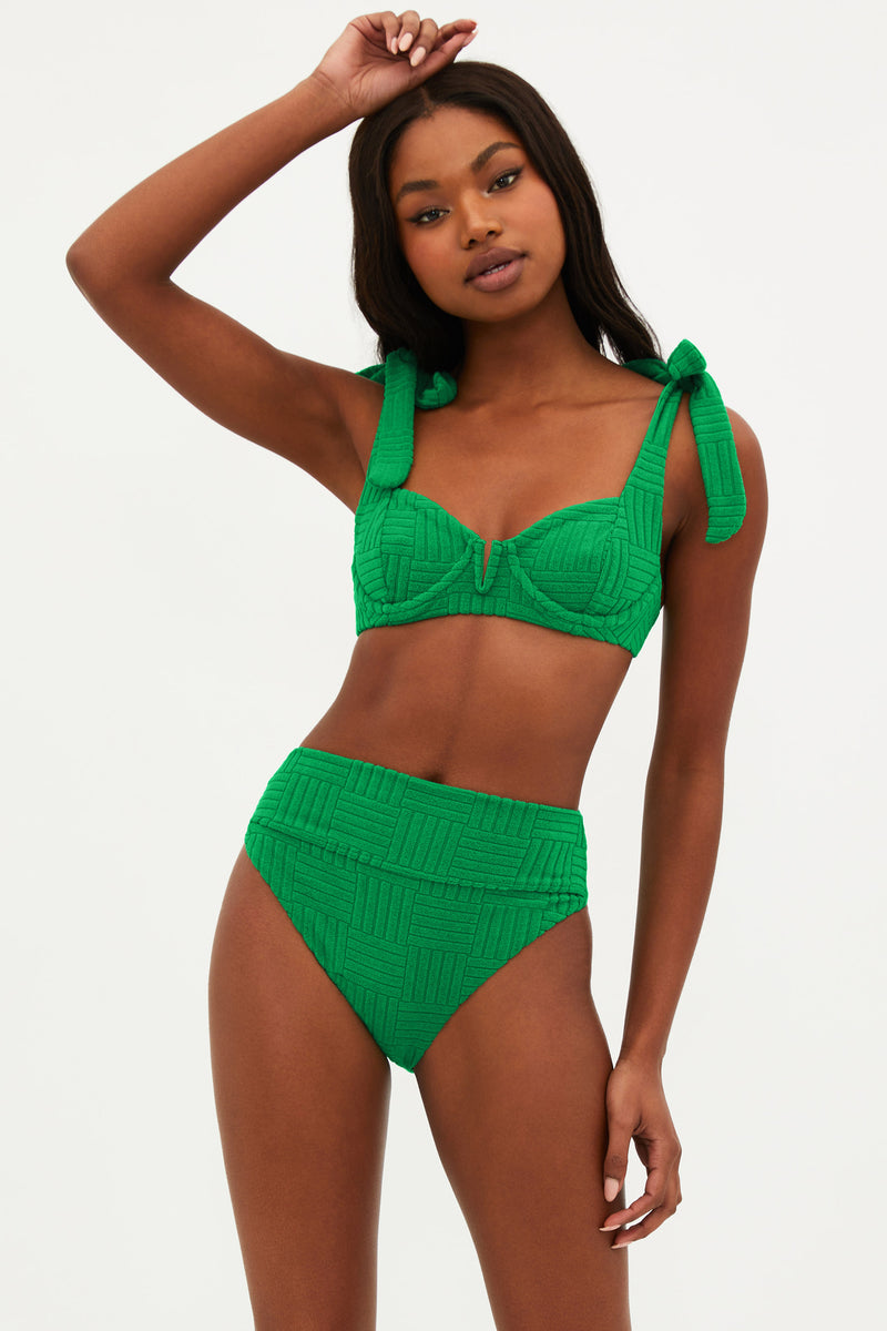 A woman wearing a jelly bean green bikini top with a sweetheart neckline and self-tie shoulders, paired with a matching high-waisted bikini bottom. Both pieces are made from a textured jacquard fabric.